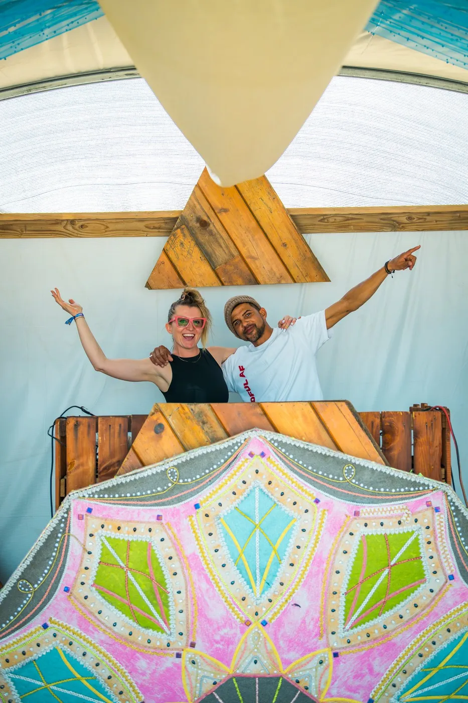 Two DJs cheering from the painted Oasis booth