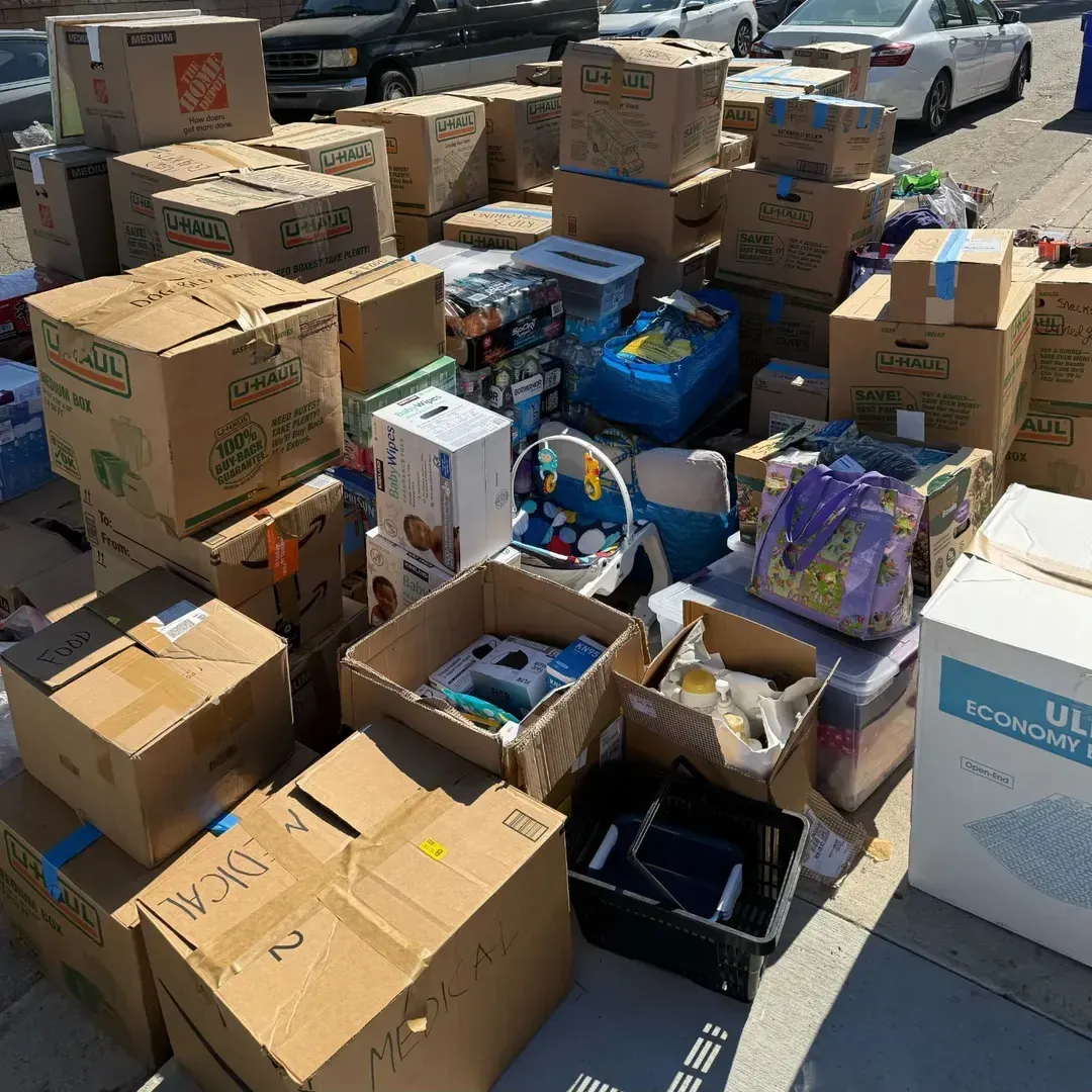 Stacks of donated boxes and supplies collected for LA wildfire relief