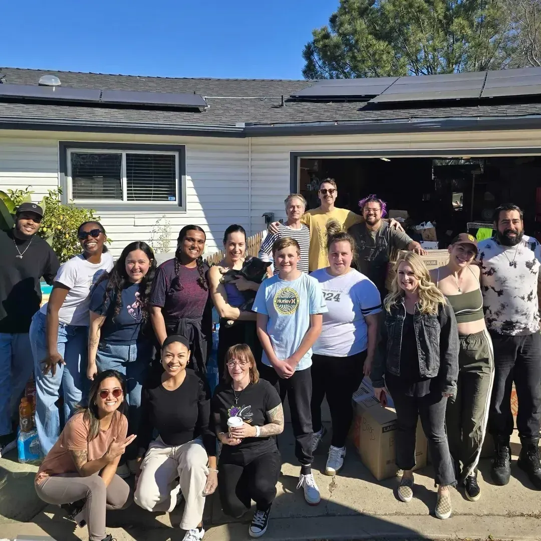 Volunteers gathered for a group photo outside a house during the relief drive